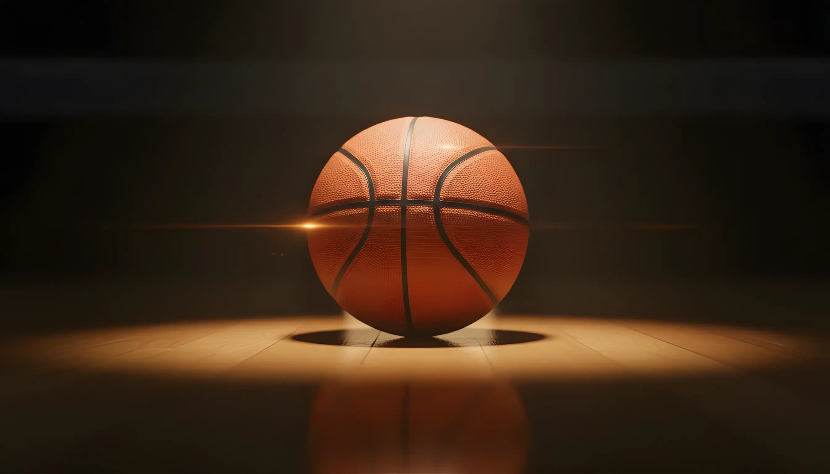 Μπάλα μπάσκετ σε φωτισμένο παρκέ γηπέδου με δραματικό φωτισμό